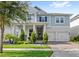 Charming two-story home with a 2-car garage, well-maintained lawn, and front garden at 15343 Lebeau Loop, Winter Garden, FL 34787