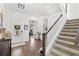 Welcoming foyer with hardwood floors, staircase, and views into the living spaces at 15343 Lebeau Loop, Winter Garden, FL 34787