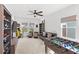 Spacious game room with foosball table, arcade game, stylish seating, and plenty of natural light at 15343 Lebeau Loop, Winter Garden, FL 34787
