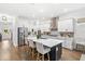 Bright and modern kitchen with stainless steel appliances, white cabinetry, quartz countertops, and spacious island at 15343 Lebeau Loop, Winter Garden, FL 34787
