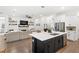 Open concept kitchen and living area with a fireplace, large sectional sofa, and island with seating at 15343 Lebeau Loop, Winter Garden, FL 34787