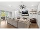 Cozy living room with a fireplace, large sectional sofa, and access to the patio at 15343 Lebeau Loop, Winter Garden, FL 34787