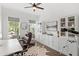 Bright home office with a large desk, built-in cabinets, and natural light from the windows at 15343 Lebeau Loop, Winter Garden, FL 34787
