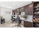 Bright home office featuring custom built-in cabinets, dual desks, and modern fixtures at 15343 Lebeau Loop, Winter Garden, FL 34787