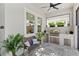 Outdoor kitchen features a built-in grill, storage, and a seating area on the patio at 15343 Lebeau Loop, Winter Garden, FL 34787