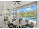 Covered patio features a dining area and an outdoor kitchen with a view of the pool at 15343 Lebeau Loop, Winter Garden, FL 34787