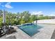 Backyard pool with waterfall feature, lounge chairs, and lush landscaping at 15343 Lebeau Loop, Winter Garden, FL 34787