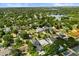 Expansive aerial view of a residential neighborhood with a lake and city skyline in the distance at 1541 Chestnut Ave, Winter Park, FL 32789