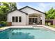 Stunning backyard with a sparkling pool and stylish covered patio area at 1541 Chestnut Ave, Winter Park, FL 32789