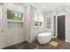 Bright bathroom featuring a modern shower with glass doors and a separate soaking tub at 1541 Chestnut Ave, Winter Park, FL 32789