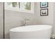 Close up of the bathroom featuring a modern tub with chrome faucet and serene natural light at 1541 Chestnut Ave, Winter Park, FL 32789