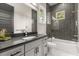 Bathroom with gray vanity, shower over tub, and modern fixtures at 1541 Chestnut Ave, Winter Park, FL 32789