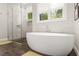 Bright bathroom featuring a modern shower with glass doors and a separate soaking tub at 1541 Chestnut Ave, Winter Park, FL 32789