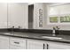 Modern bathroom featuring double sinks, sleek black countertops, and stylish fixtures at 1541 Chestnut Ave, Winter Park, FL 32789