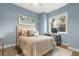 Cozy bedroom with a comfortable bed, soft lighting, and a workspace by the window at 1541 Chestnut Ave, Winter Park, FL 32789