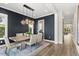 Dining room boasts modern lighting, dark walls, and a view into the next room at 1541 Chestnut Ave, Winter Park, FL 32789