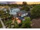 Aerial view of a modern two-story home with professional landscaping and a brick driveway at 1541 Chestnut Ave, Winter Park, FL 32789