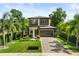 Stunning modern two-story home with lush landscaping and a paved driveway at 1541 Chestnut Ave, Winter Park, FL 32789