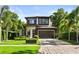 Two-story home boasts a well-manicured lawn, modern garage door, and meticulous landscaping at 1541 Chestnut Ave, Winter Park, FL 32789