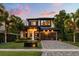 Beautiful two-story home with well-manicured lawn, updated garage door, and gorgeous landscaping at 1541 Chestnut Ave, Winter Park, FL 32789