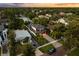 An aerial view of a home with a paved driveway, backyard, and professional landscaping at 1541 Chestnut Ave, Winter Park, FL 32789