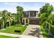 Beautiful modern home with lush landscaping, a paved driveway, and curb appeal at 1541 Chestnut Ave, Winter Park, FL 32789