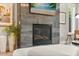 Living room detail featuring a modern fireplace with sleek stonework and a mounted television at 1541 Chestnut Ave, Winter Park, FL 32789