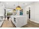 Large kitchen island features a quartz countertop and stainless steel appliances, great for entertaining at 1541 Chestnut Ave, Winter Park, FL 32789