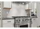 Close up of the stainless steel range and backsplash in this modern gourmet kitchen at 1541 Chestnut Ave, Winter Park, FL 32789