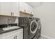 Modern laundry room featuring new washer, dryer, patterned floors, and storage cabinets at 1541 Chestnut Ave, Winter Park, FL 32789