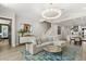 Spacious living room with a modern chandelier, stylish furniture, and open access to the kitchen at 1541 Chestnut Ave, Winter Park, FL 32789