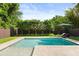 Inviting pool area surrounded by lush landscaping and a privacy fence at 1541 Chestnut Ave, Winter Park, FL 32789
