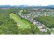 A scenic aerial view of a community located near a golf course and surrounded by lush greenery and trees at 157 Bell Tower E Xing, Kissimmee, FL 34759