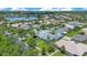 Aerial view of homes within a well-maintained community, surrounded by trees and a lake at 157 Bell Tower E Xing, Kissimmee, FL 34759