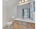 Bright bathroom with a shower-tub combo and large mirror over the sink at 157 Bell Tower E Xing, Kissimmee, FL 34759