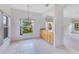 Bright dining area with views from multiple windows, bar-height countertop and tile flooring at 157 Bell Tower E Xing, Kissimmee, FL 34759