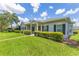 Traditional home with green lawn, manicured bushes, symmetrical windows, and a covered porch at 157 Bell Tower E Xing, Kissimmee, FL 34759