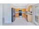 Light filled kitchen with stainless steel appliances, wood cabinets, and tile flooring at 157 Bell Tower E Xing, Kissimmee, FL 34759