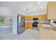 Bright kitchen featuring stainless steel appliances, light wood cabinets, and tile flooring at 157 Bell Tower E Xing, Kissimmee, FL 34759