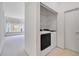 Laundry room with washer/dryer combo, wire shelving, and direct access to the living area at 157 Bell Tower E Xing, Kissimmee, FL 34759