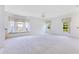 Bright, neutral living room with large windows and plush carpeting, bathed in natural light at 157 Bell Tower E Xing, Kissimmee, FL 34759