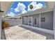 View of the screened-in patio with block paved flooring, offering a tranquil outdoor space at 157 Bell Tower E Xing, Kissimmee, FL 34759