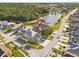 Overhead view featuring the home's location with lush landscaping, close to a lake, and surrounded by trees at 16602 Citrus Pkwy, Clermont, FL 34714
