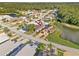 Aerial view displaying the house with a lake nearby, mature trees, and convenient neighborhood location at 16602 Citrus Pkwy, Clermont, FL 34714