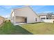 Exterior view of the home with a covered patio and a spacious, well-maintained lawn at 16602 Citrus Pkwy, Clermont, FL 34714