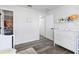 Bedroom featuring white furnishings, wood-look floors, and access to a closet and additional rooms at 16602 Citrus Pkwy, Clermont, FL 34714