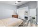 Well-lit bedroom with wood-look floors, neutral paint, and convenient access to the bathroom at 16602 Citrus Pkwy, Clermont, FL 34714