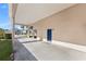 Covered carport providing ample parking space, featuring a blue door and an inviting entrance at 16602 Citrus Pkwy, Clermont, FL 34714