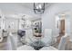 Open-concept dining area with modern glass table, adjacent to an updated kitchen at 16602 Citrus Pkwy, Clermont, FL 34714