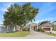 A quaint single-story home with a spacious covered carport and lush lawn under a mature tree at 16602 Citrus Pkwy, Clermont, FL 34714